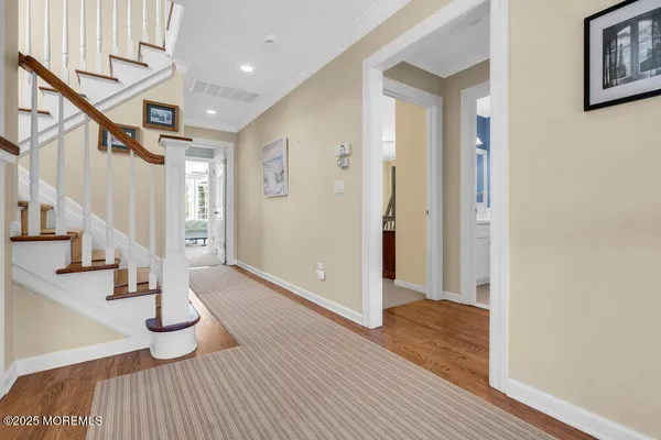 a view of entryway and hall with wooden floor