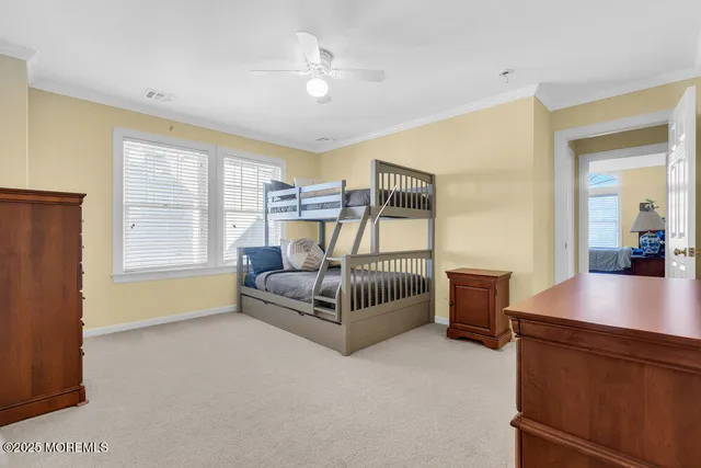 a spacious bedroom with a bed and a chandelier