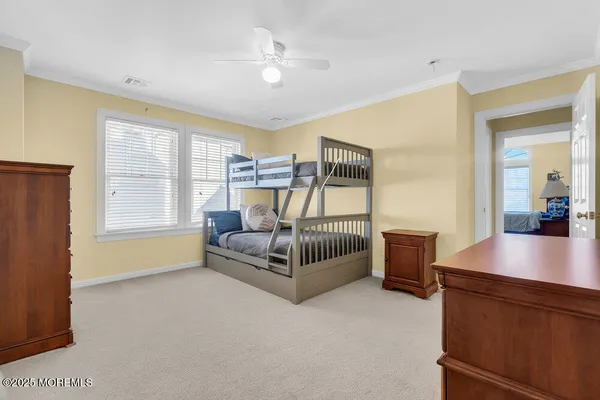 a spacious bedroom with a bed and a chandelier