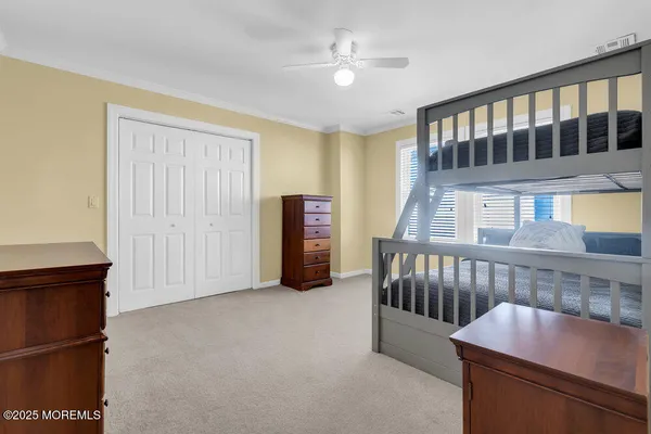 a living room with furniture and a baby crib