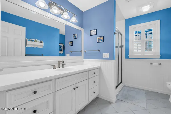 a bathroom with a double vanity sink and a mirror