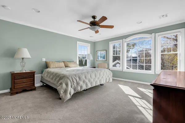 a spacious bedroom with a bed and a window