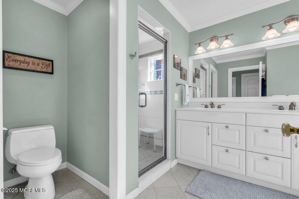 412 Chicago Boulevard Sea Girt, NJ 08750 - Photo 30 of 47 a bathroom with a toilet sink and mirror