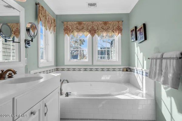 a bathroom with a tub sink and window