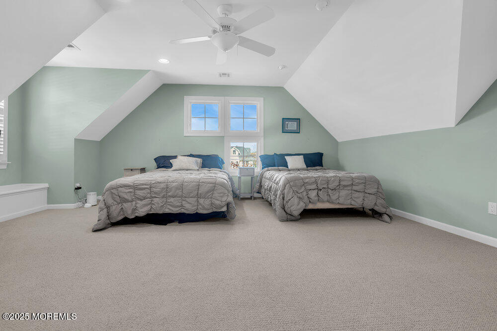 412 Chicago Boulevard Sea Girt, NJ 08750 - Photo 34 of 47 a living room with two bed furniture and a chandelier