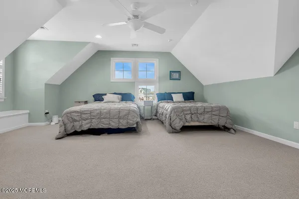 a living room with two bed furniture and a chandelier