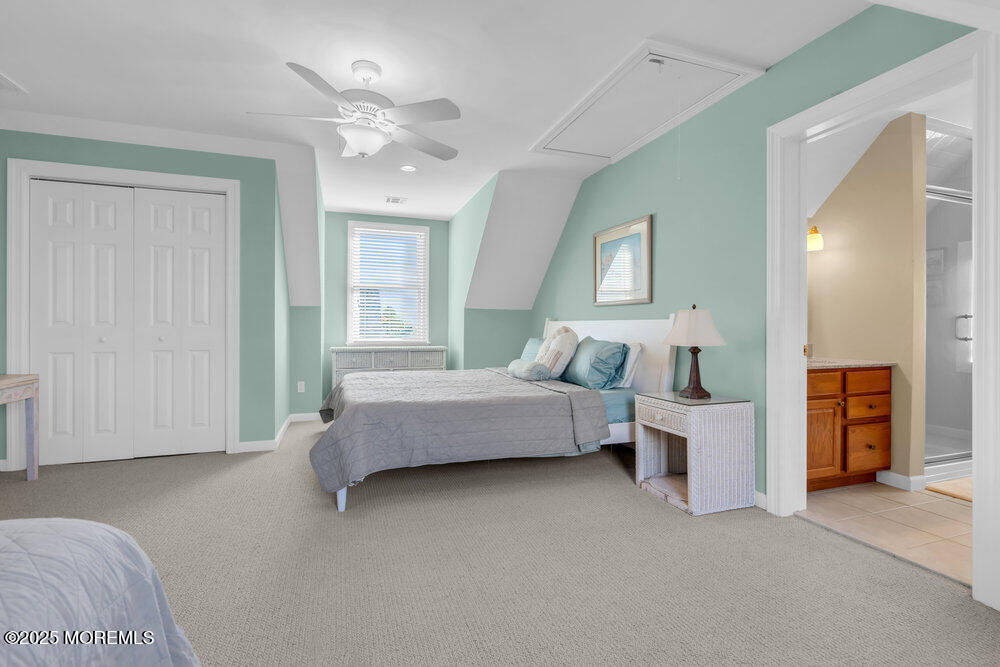 412 Chicago Boulevard Sea Girt, NJ 08750 - Photo 39 of 47 a spacious bedroom with a bed and a chandelier