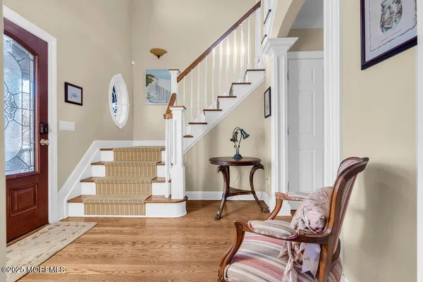 a view of entryway and hall with wooden floor