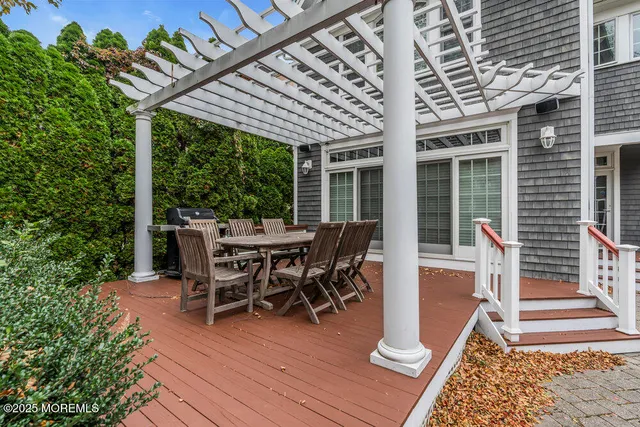 a view of a patio with a table and chairs next to a yard