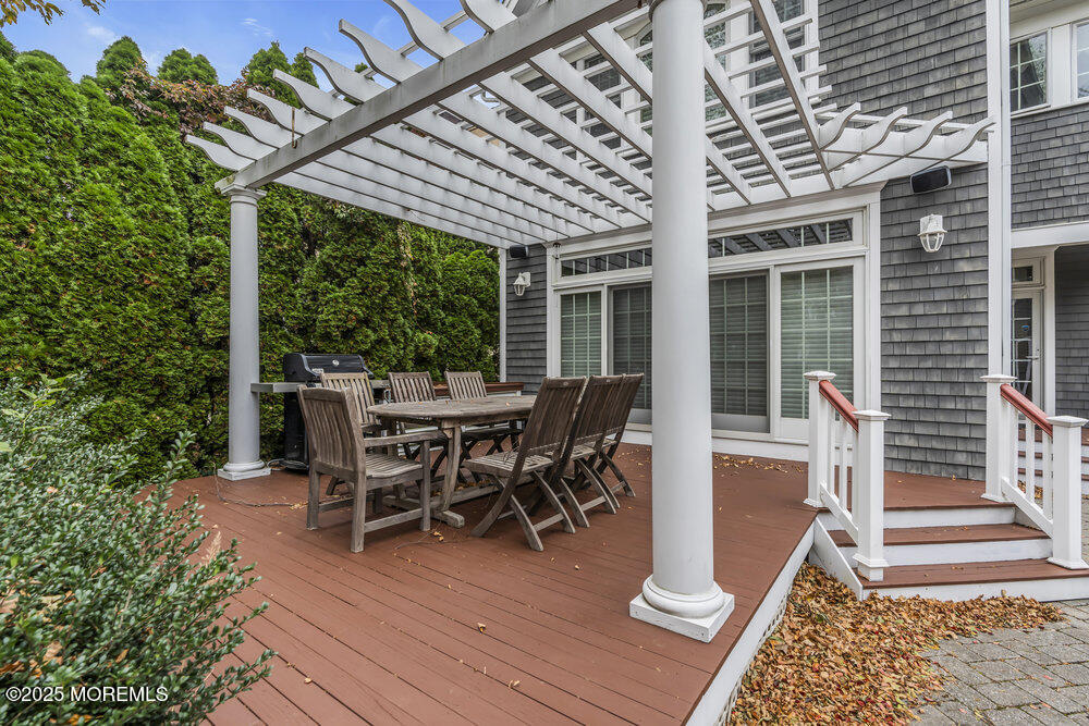 412 Chicago Boulevard Sea Girt, NJ 08750 - Photo 46 of 47 a view of a patio with a table and chairs next to a yard