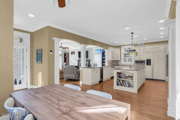 a living room with kitchen island furniture and a wooden floor