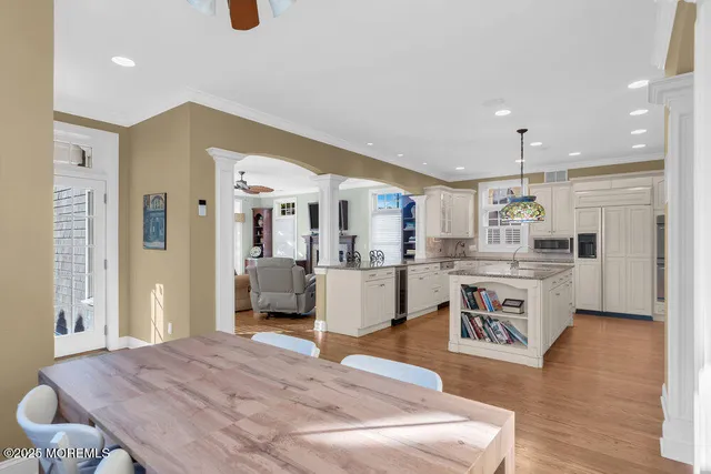 a living room with kitchen island furniture and a wooden floor