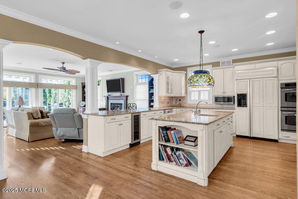 412 Chicago Boulevard Sea Girt, NJ 08750 - Photo 8 of 47 a view of kitchen with granite countertop a stove top oven a sink a counter top space and living room view