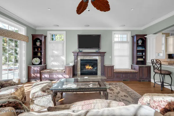 a living room with furniture fireplace and window