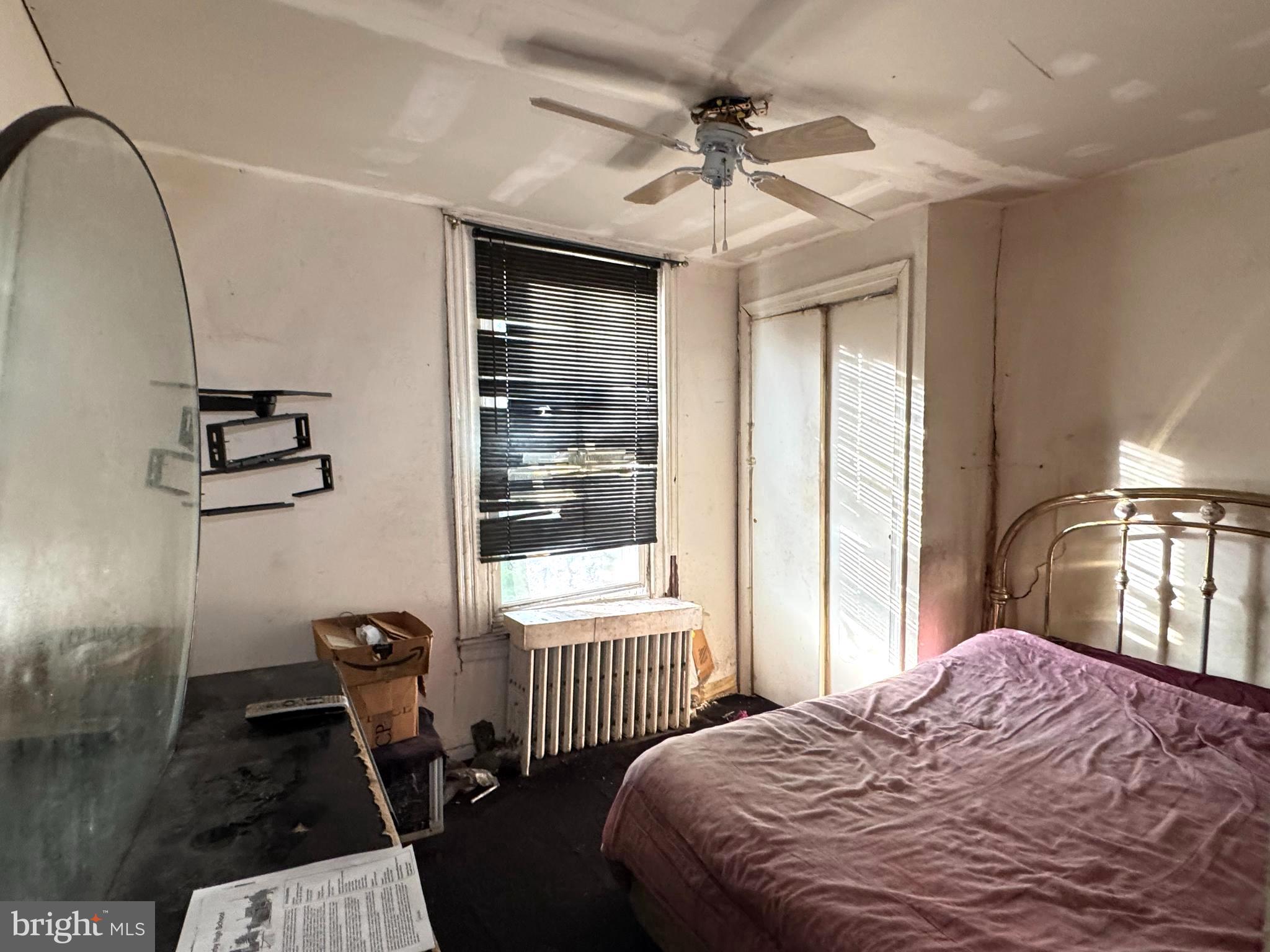 5702 Belmar Street Philadelphia, PA 19143 - Photo 8 of 14 a bedroom with a bed and a window