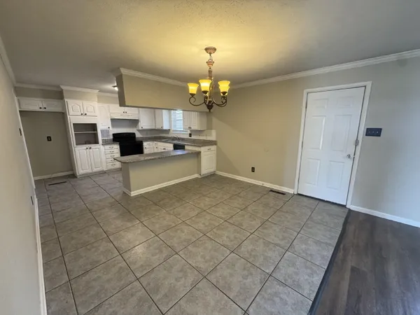 a view of a kitchen with kitchen island wooden floor and living room