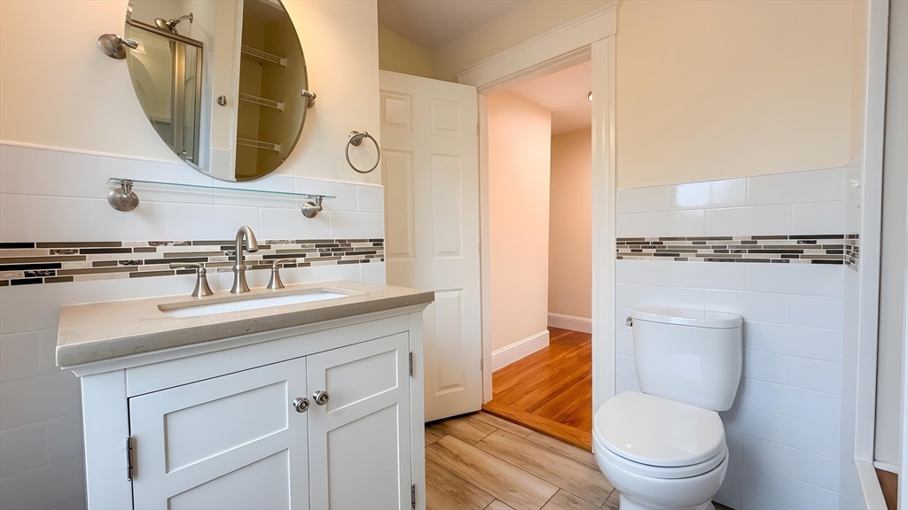 114 Curve Street Dedham, MA 02026 - Photo 13 of 27 a bathroom with a toilet a sink and a mirror
