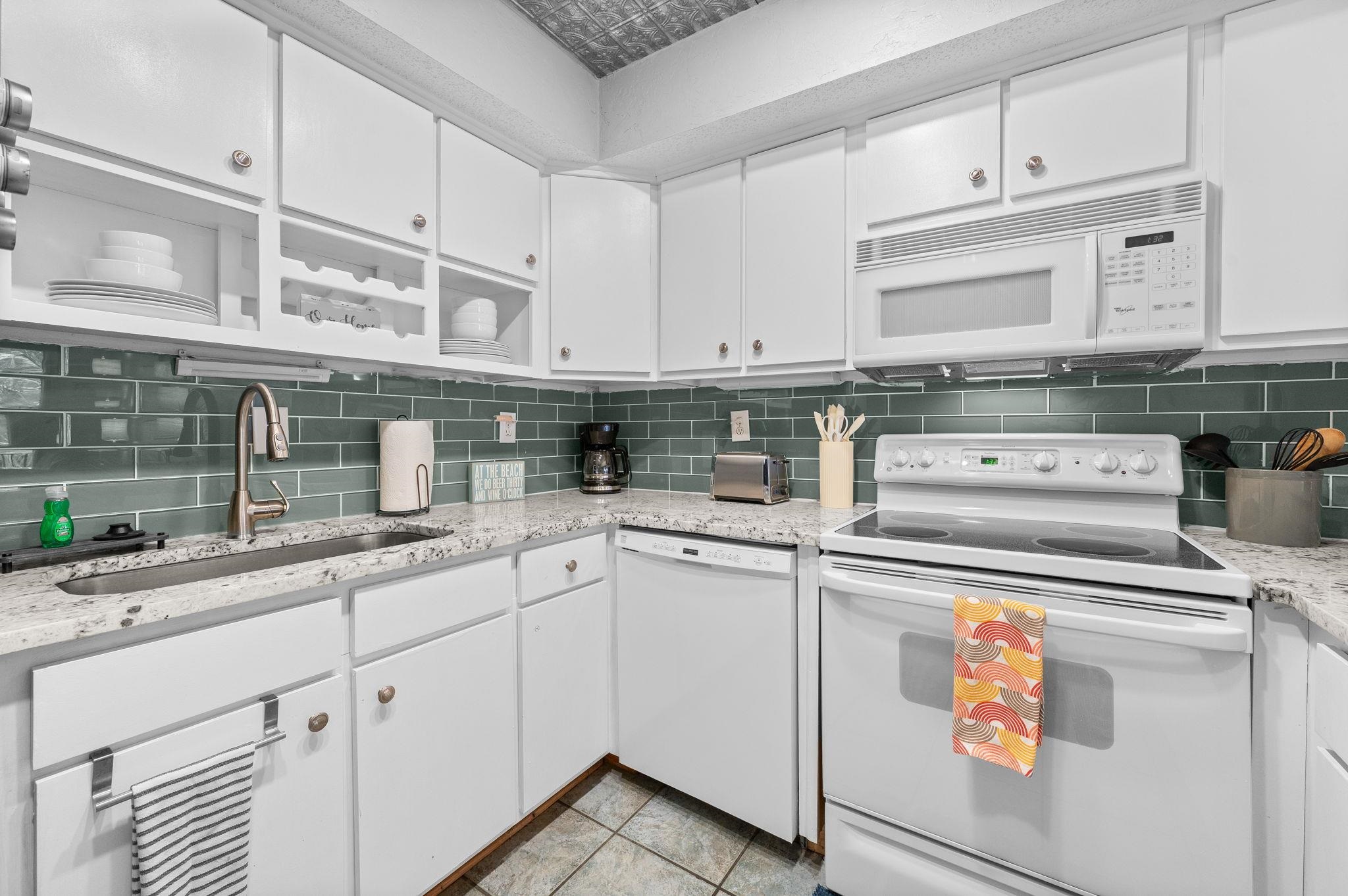 7175 A1A South, Unit F237 St. Augustine, FL 32080 - Photo 13 of 63 a kitchen with granite countertop cabinets stainless steel appliances and sink