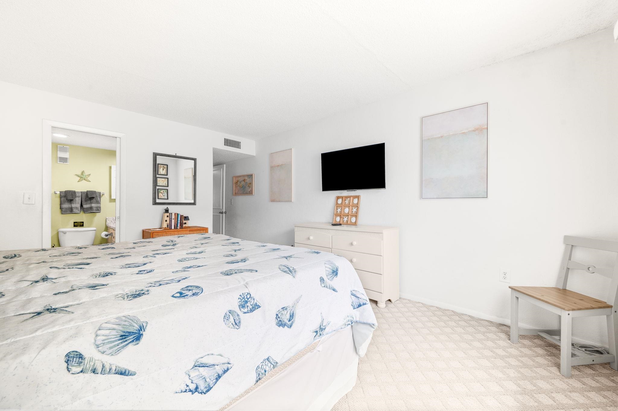 7175 A1A South, Unit F237 St. Augustine, FL 32080 - Photo 22 of 63 a bedroom with a bed and a flat screen tv