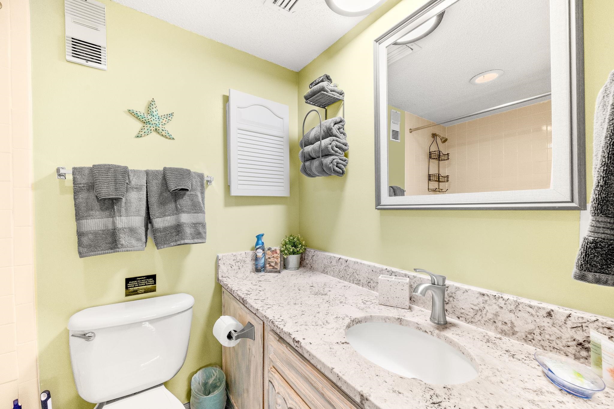 7175 A1A South, Unit F237 St. Augustine, FL 32080 - Photo 23 of 63 a bathroom with a granite countertop vanity a sink and a mirror