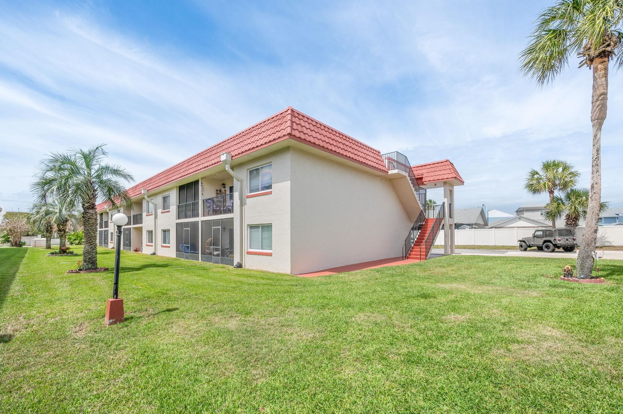 7175 A1A South, Unit F237 St. Augustine, FL 32080 - Photo 35 of 63 a view of a house with a yard and a garden