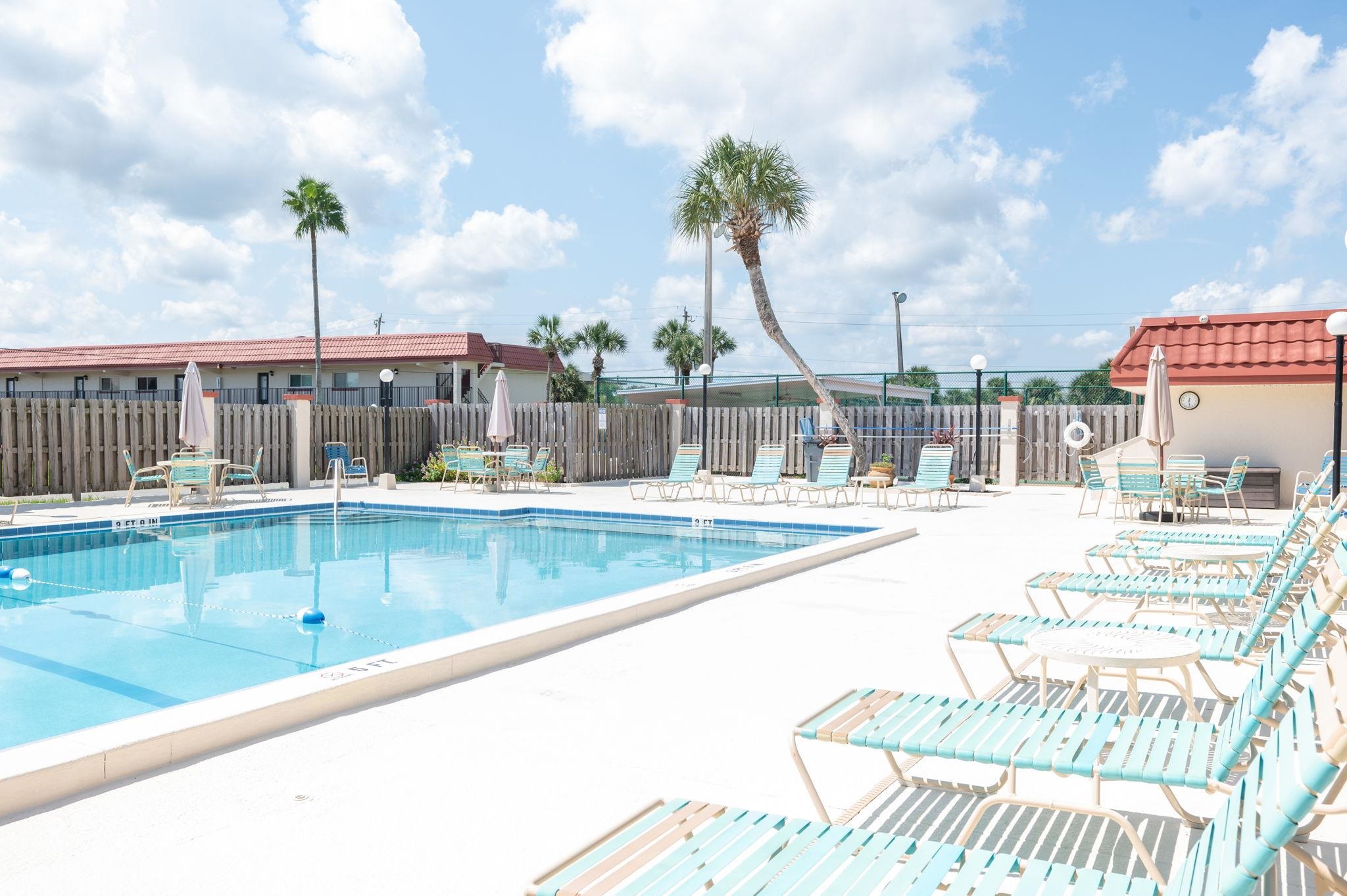 7175 A1A South, Unit F237 St. Augustine, FL 32080 - Photo 38 of 63 a view of a swimming pool with a lawn chairs