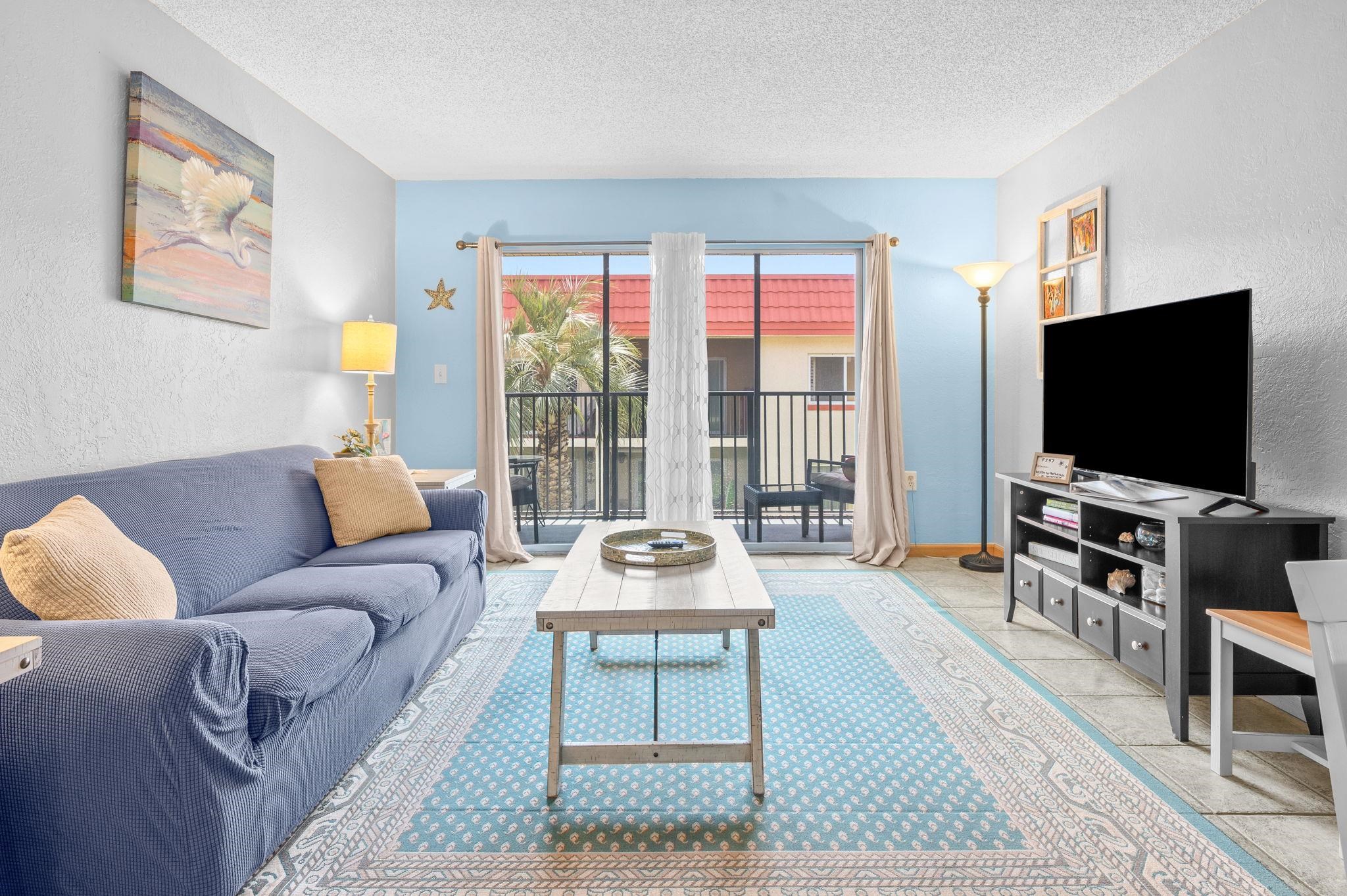 7175 A1A South, Unit F237 St. Augustine, FL 32080 - Photo 4 of 63 a living room with furniture and a flat screen tv