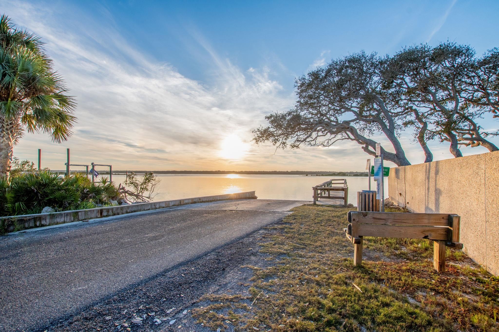 7175 A1A South, Unit F237 St. Augustine, FL 32080 - Photo 50 of 63 a view of a ocean with a bench and trees around
