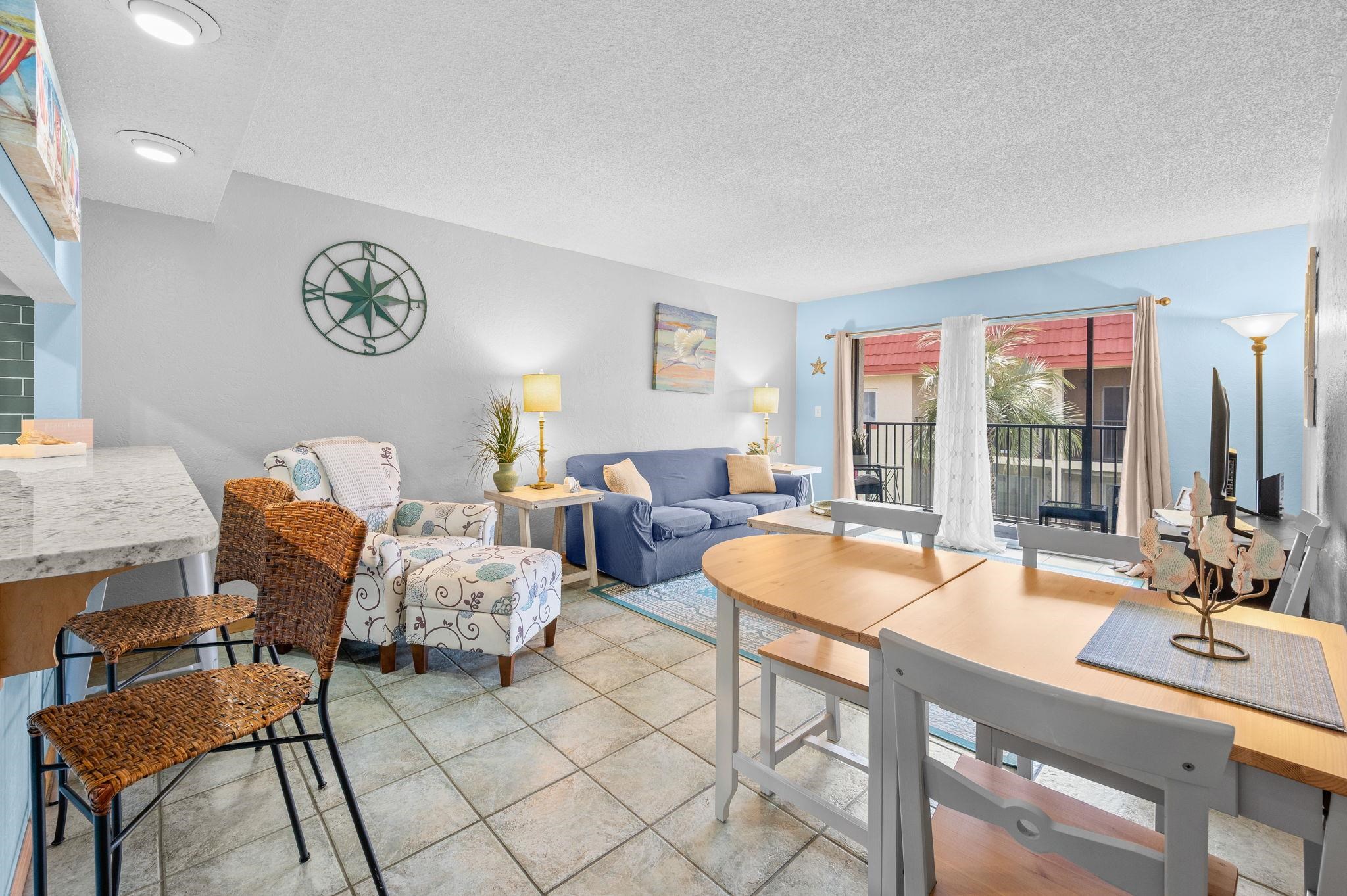 7175 A1A South, Unit F237 St. Augustine, FL 32080 - Photo 5 of 63 a living room with furniture a table and a large window