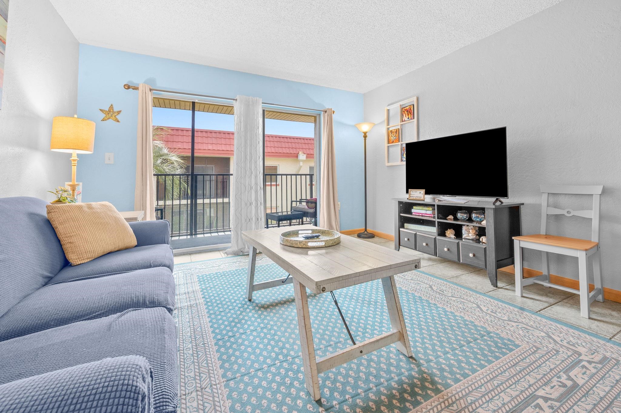 7175 A1A South, Unit F237 St. Augustine, FL 32080 - Photo 6 of 63 a living room with furniture and a flat screen tv