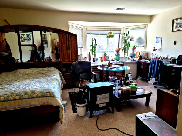 a living room filled with furniture and a mirror
