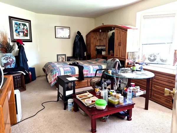 a bedroom with a bed and a window