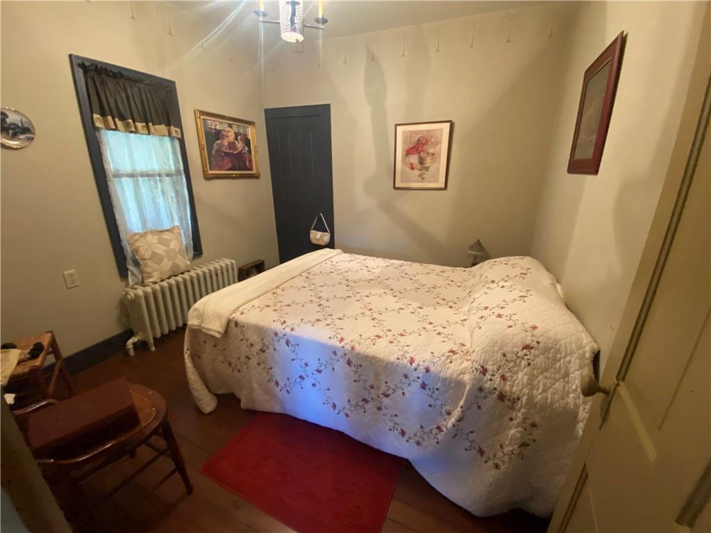 1120 Fredonia Road Hadley, PA 16130 - Photo 18 of 23 a bedroom with a bed and wooden floor