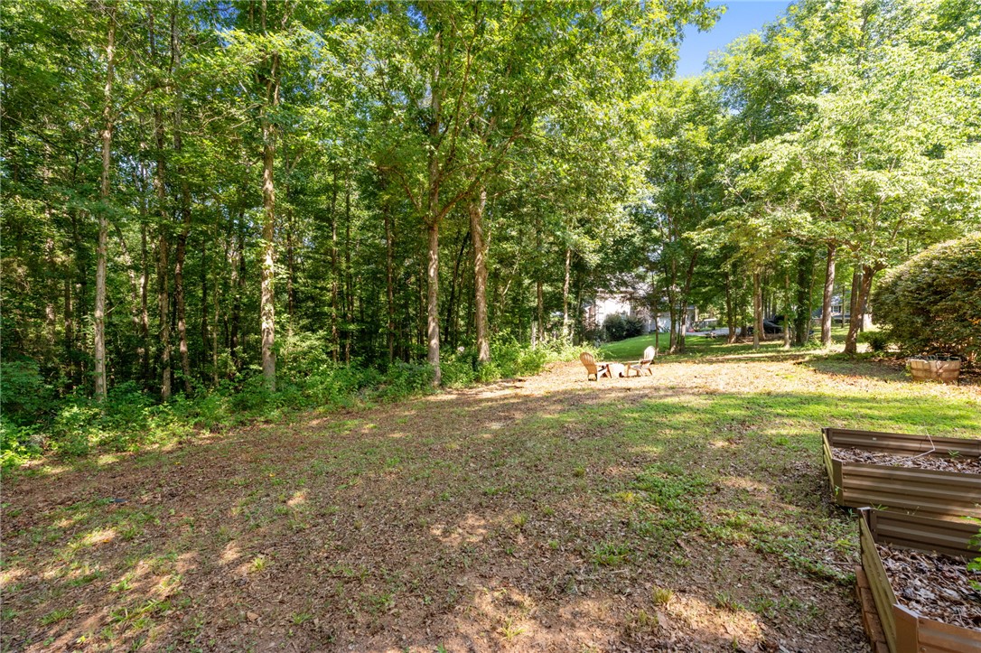 108 Winterbrook Circle Seneca, SC 29678 - Photo 35 of 40 A tranquil backyard haven offers a shaded lawn and cozy outdoor seating, perfect for quiet enjoyment.