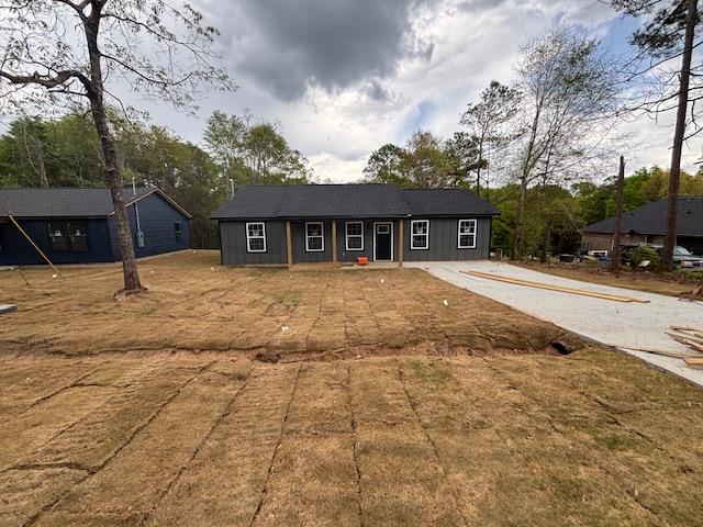 a front view of house with yard and trees around
