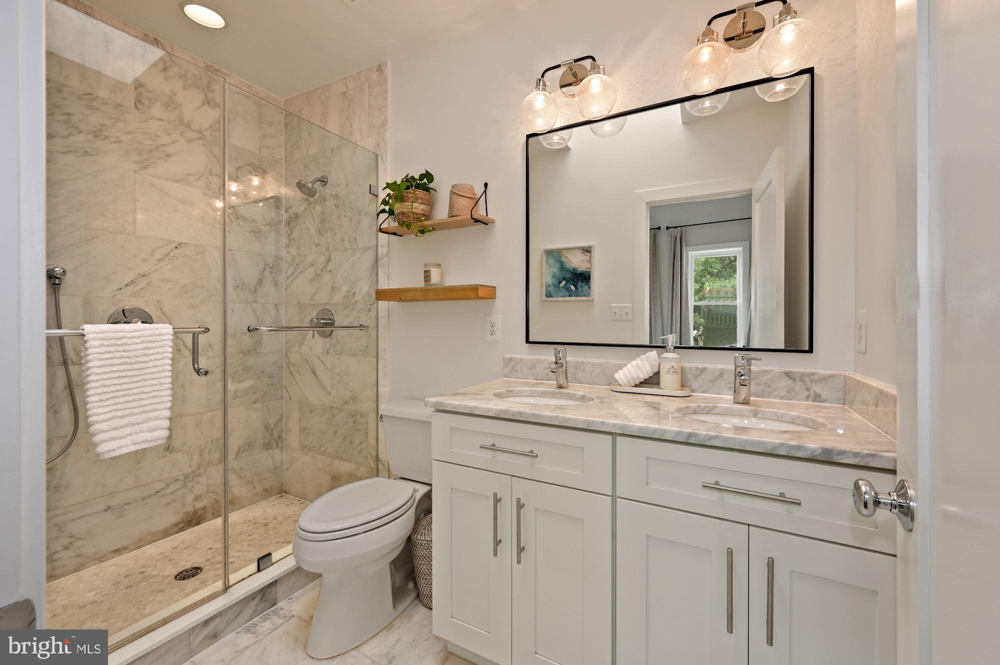 4110 3rd Street Northwest Washington, DC 20011 - Photo 20 of 35 a bathroom with a granite countertop toilet sink shower and mirror