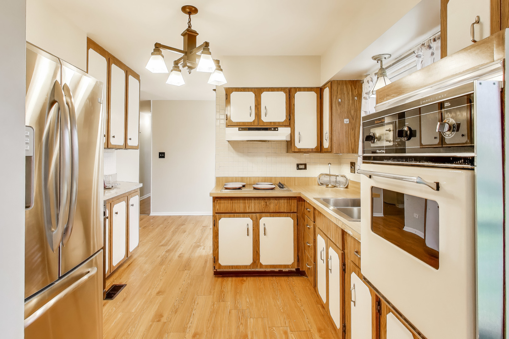 400 Landmeier Road Elk Grove Village, IL 60007 - Photo 12 of 33 a kitchen with stainless steel appliances a stove a sink and a refrigerator