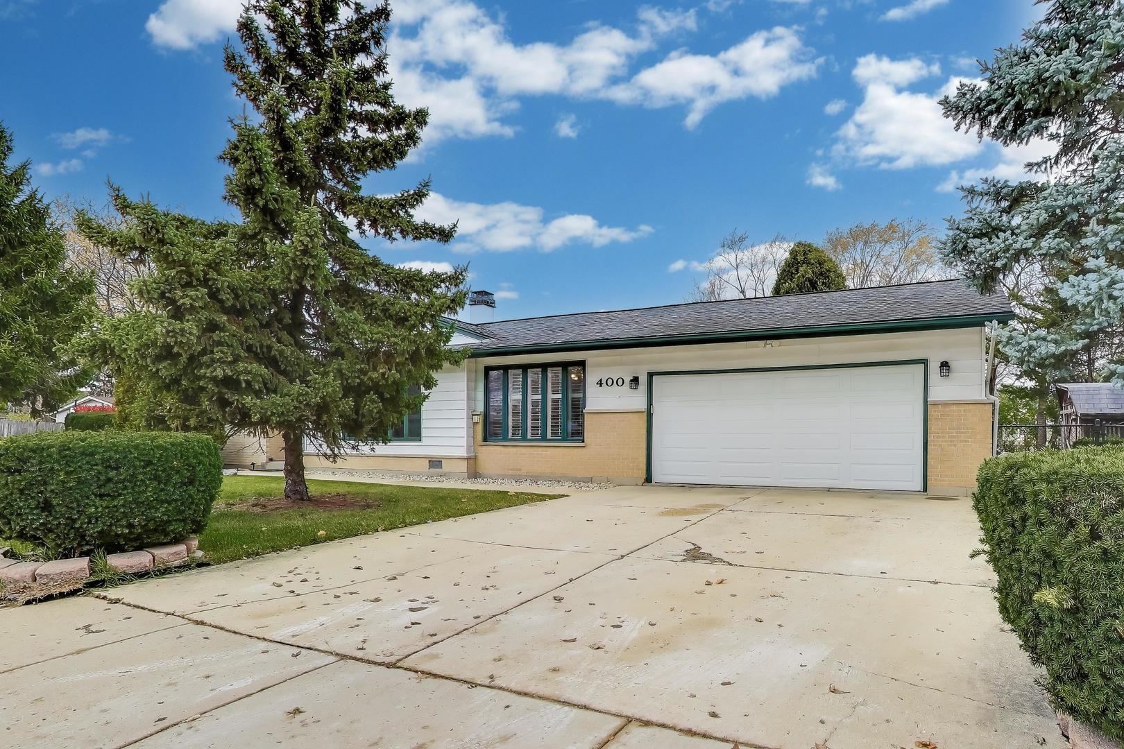 400 Landmeier Road Elk Grove Village, IL 60007 - Photo 2 of 33 a front view of a house with a yard and garage