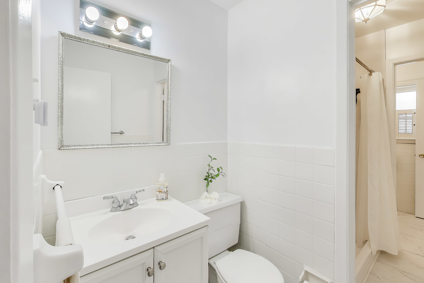 400 Landmeier Road Elk Grove Village, IL 60007 - Photo 23 of 33 a bathroom with a sink a toilet and mirror