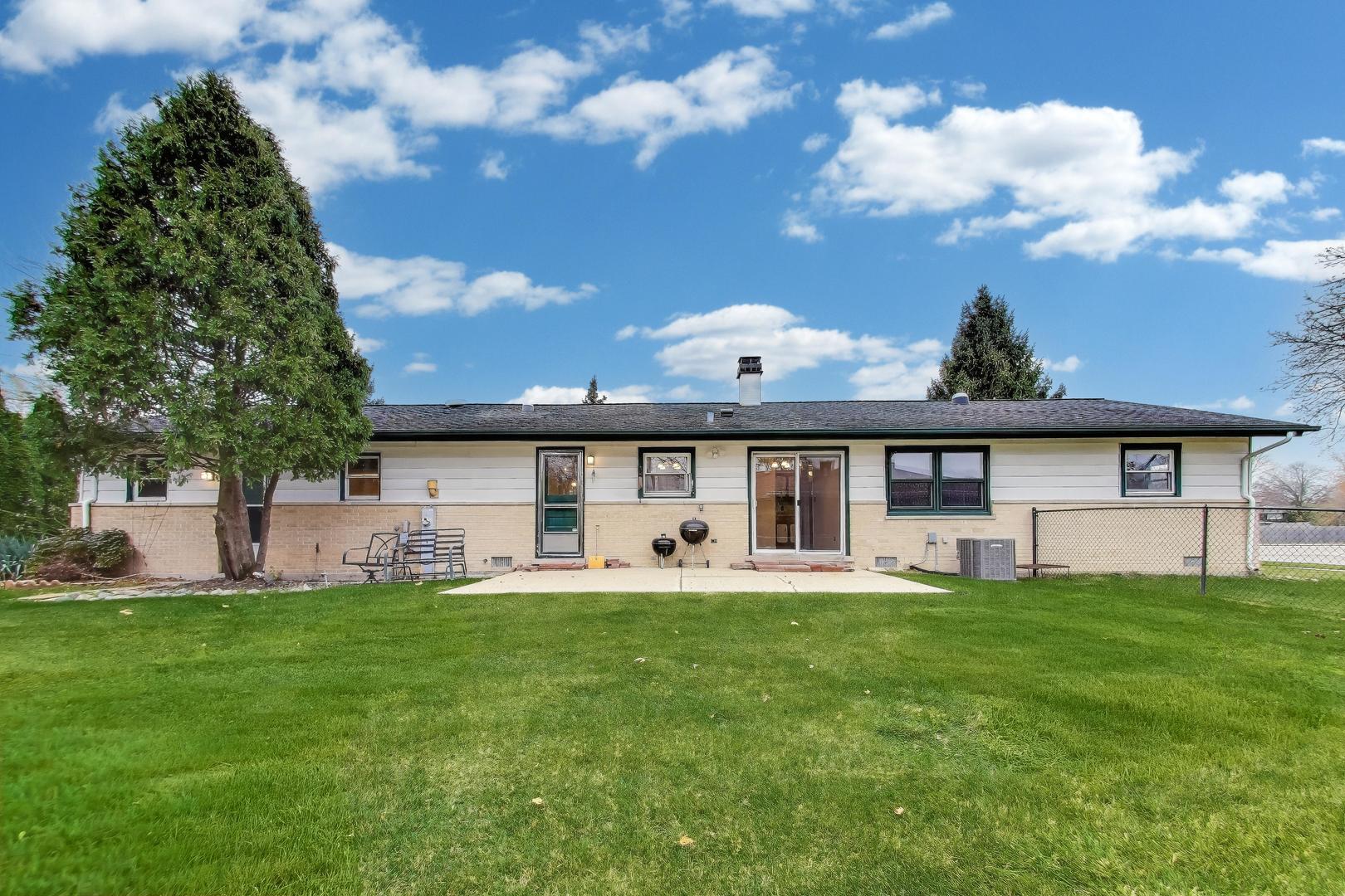 400 Landmeier Road Elk Grove Village, IL 60007 - Photo 29 of 33 a front view of a house with a garden and trees
