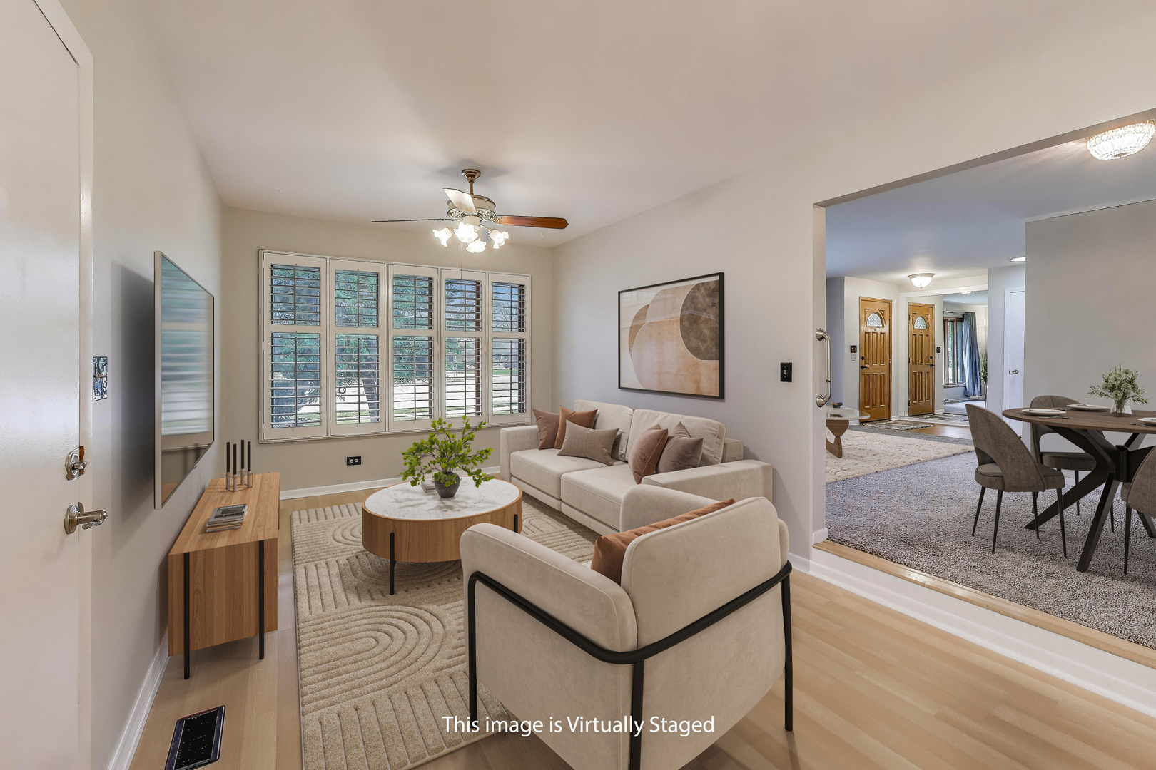400 Landmeier Road Elk Grove Village, IL 60007 - Photo 9 of 33 a living room with furniture a chandelier and a flat screen tv