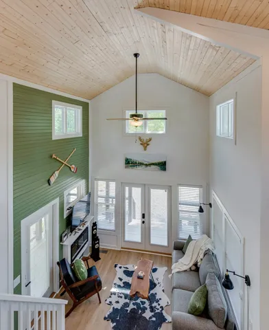 a living room with furniture windows and a chandelier