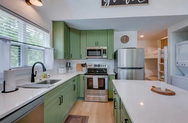 a kitchen with stainless steel appliances a sink stove and refrigerator