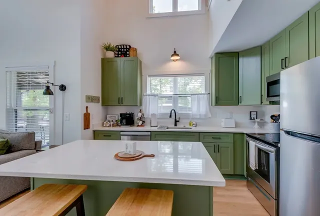 a kitchen with a sink cabinets and window