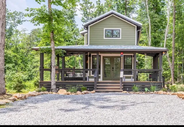 a front view of a house with a garden and plants