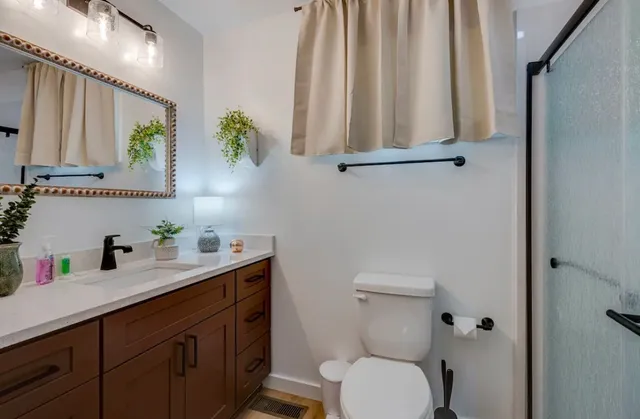a bathroom with a toilet sink and mirror