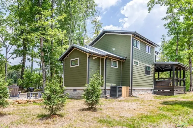 a backyard of a house with yard and outdoor seating