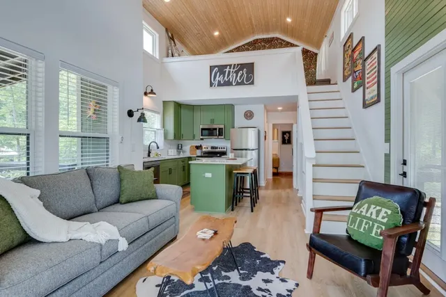 a living room with furniture and painting on the wall
