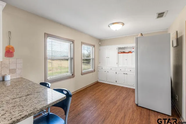 a view of kitchen with furniture and wooden floor