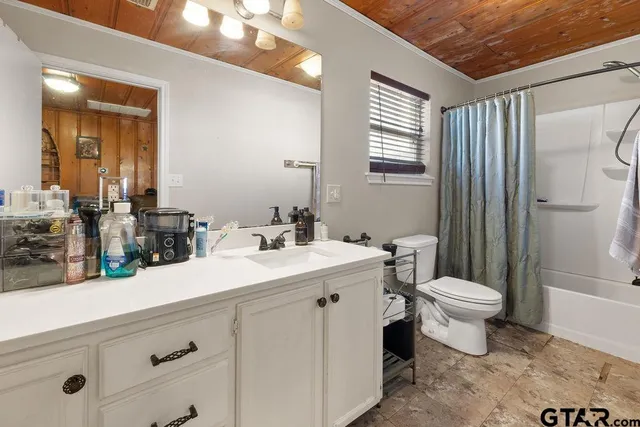 a bathroom with a double vanity sink toilet and shower